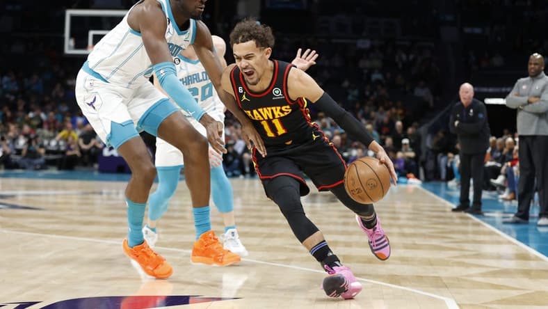Feb 13, 2023; Charlotte, North Carolina, USA; Atlanta Hawks guard Trae Young (11) drives past Charlotte Hornets center Mark Williams (5) during the first quarter at Spectrum Center. Mandatory Credit: Brian Westerholt-USA TODAY Sports