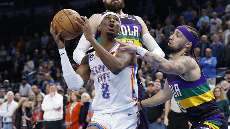 Feb 13, 2023; Oklahoma City, Oklahoma, USA; Oklahoma City Thunder guard Shai Gilgeous-Alexander (2) is defended by New Orleans Pelicans forward Herbert Jones (5) on a drive to the basket during the first quarter at Paycom Center. Mandatory Credit: Alonzo Adams-USA TODAY Sports