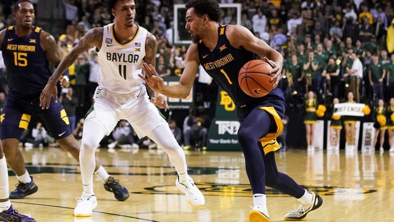 Feb 13, 2023; Waco, Texas, USA; West Virginia Mountaineers forward Emmitt Matthews Jr. (1) works past Baylor Bears forward Jalen Bridges (11) during the first half at Ferrell Center. Mandatory Credit: Raymond Carlin III-USA TODAY Sports