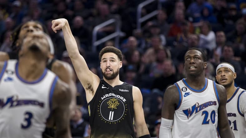 Feb 13, 2023; San Francisco, California, USA; Golden State Warriors guard Klay Thompson (11) watches his shot drop against the Washington Wizards during the first half at Chase Center. Mandatory Credit: John Hefti-USA TODAY Sports