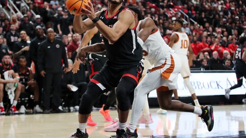 Feb 13, 2023; Lubbock, Texas, USA; Texas Tech Red Raiders forward Kevin Obanor (0) stops to shoot against Texas Longhorns guard Marcus Carr (5) in the second half at United Supermarkets Arena. Mandatory Credit: Michael C. Johnson-USA TODAY Sports