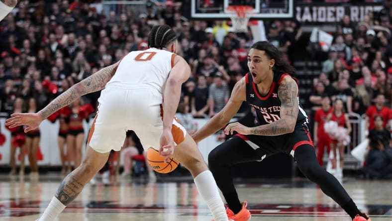 Feb 13, 2023; Lubbock, Texas, USA; Texas Tech Red Raiders forward Jaylon Tyson (20) works the ball against Texas Longhorns forward Timmy Allen (0) in the second half at United Supermarkets Arena. Mandatory Credit: Michael C. Johnson-USA TODAY Sports