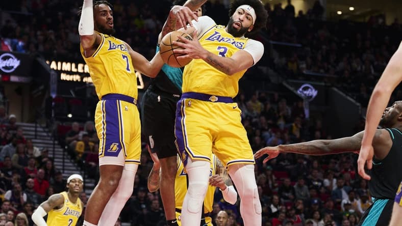 Feb 13, 2023; Portland, Oregon, USA; Los Angeles Lakers forward Anthony Davis (3) grabs a rebound during the second half against Portland Trail Blazers guard Anfernee Simons (1) at Moda Center. Mandatory Credit: Troy Wayrynen-USA TODAY Sports
