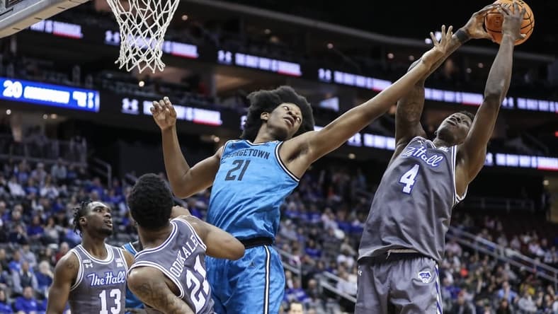 Feb 14, 2023; Newark, New Jersey, USA;  Georgetown Hoyas center Ryan Mutombo (21) and Seton Hall Pirates forward Tyrese Samuel (4) fight for a rebound in the first half at Prudential Center. Mandatory Credit: Wendell Cruz-USA TODAY Sports