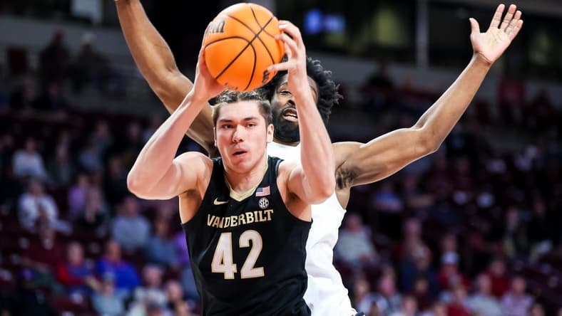 Feb 14, 2023; Columbia, South Carolina, USA; Vanderbilt Commodores forward Quentin Millora-Brown (42) grabs a rebound over South Carolina Gamecocks forward Josh Gray (33) in the first half at Colonial Life Arena. Mandatory Credit: Jeff Blake-USA TODAY Sports