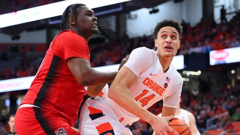 Feb 14, 2023; Syracuse, New York, USA; Syracuse Orange center Jesse Edwards (14) drives to the basket as North Carolina State Wolfpack forward D.J. Burns Jr. (30) defends during the first half at the JMA Wireless Dome. Mandatory Credit: Rich Barnes-USA TODAY Sports