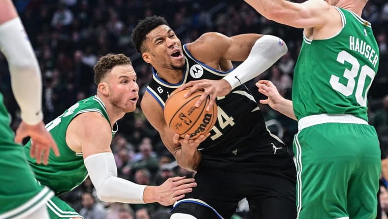 Feb 14, 2023; Milwaukee, Wisconsin, USA; Milwaukee Bucks forward Giannis Antetokounmpo (34) looks for a shot between Boston Celtics forward Blake Griffin (91) and forward Sam Hauser (30) in the first quarter at Fiserv Forum. Mandatory Credit: Benny Sieu-USA TODAY Sports