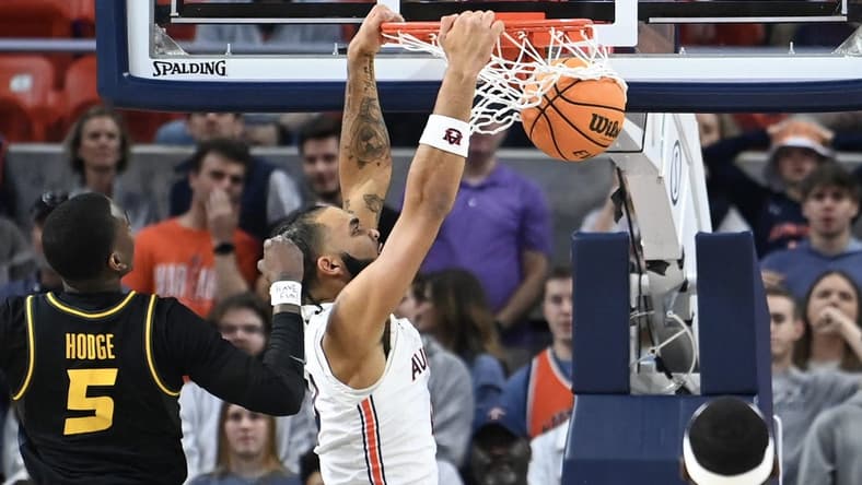 Feb 14, 2023; Auburn, Alabama, USA; Auburn Tigers forward Johni Broome (4) dunks the ball over Missouri Tigers guard D'Moi Hodge (5) during the first half at Neville Arena. Mandatory Credit: Julie Bennett-USA TODAY Sports