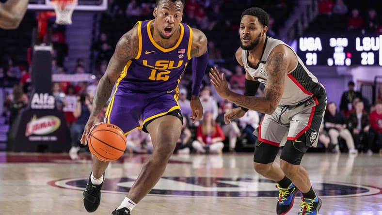 Feb 14, 2023; Athens, Georgia, USA; LSU Tigers forward KJ Williams (12) dribbles to the basket past Georgia Bulldogs forward Jailyn Ingram (15) during the first half at Stegeman Coliseum. Mandatory Credit: Dale Zanine-USA TODAY Sports