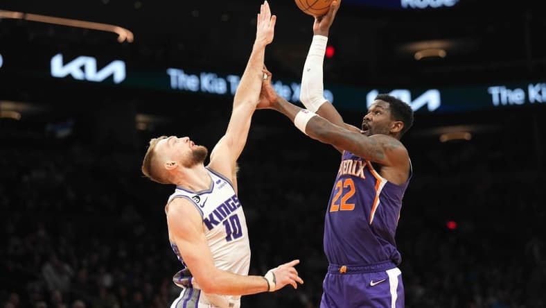 Feb 14, 2023; Phoenix, Arizona, USA; Phoenix Suns center Deandre Ayton (22) shoots over Sacramento Kings forward Domantas Sabonis (10) during the first half at Footprint Center. Mandatory Credit: Joe Camporeale-USA TODAY Sports