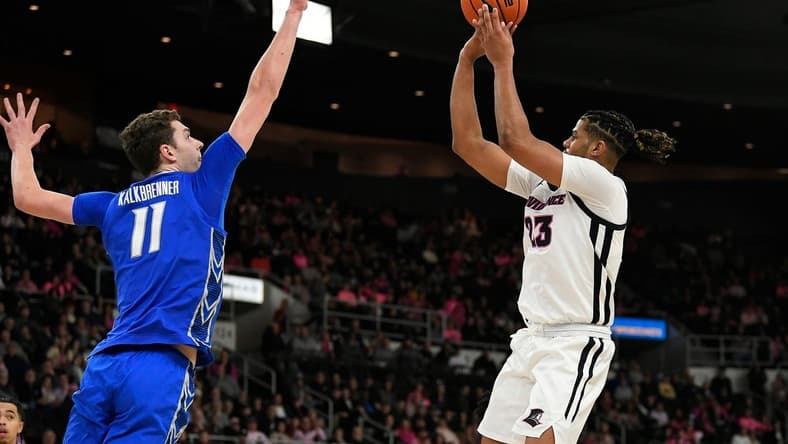 Feb 14, 2023; Providence, Rhode Island, USA; Providence Friars forward Bryce Hopkins (23) shoots over Creighton Bluejays center Ryan Kalkbrenner (11) during the first half at Amica Mutual Pavilion. Mandatory Credit: Eric Canha-USA TODAY Sports