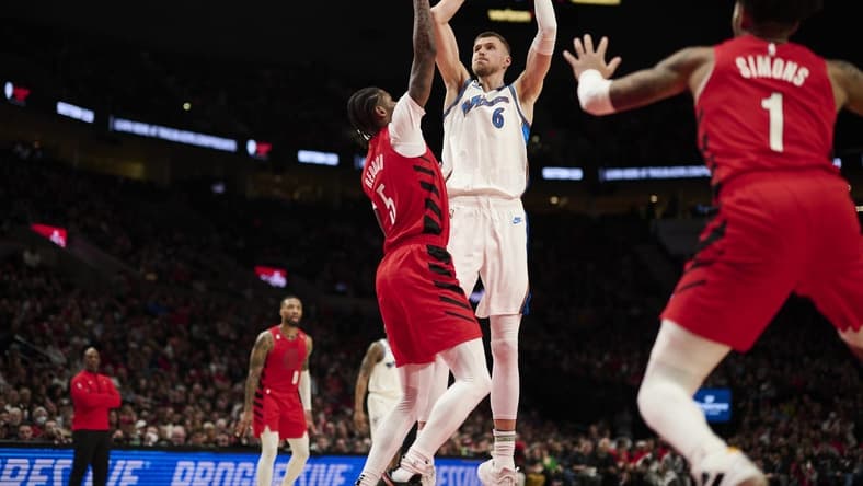 Feb 14, 2023; Portland, Oregon, USA; Washington Wizards center Kristaps Porzingis (6) shoots a jump shot during the first half against Portland Trail Blazers forward Cam Reddish (5) at Moda Center. Mandatory Credit: Troy Wayrynen-USA TODAY Sports