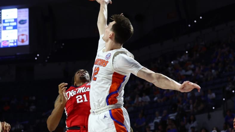Feb 15, 2023; Gainesville, Florida, USA; Florida Gators blocks the shot of Mississippi Rebels forward Robert Allen (21) during the first half at Exactech Arena at the Stephen C. O'Connell Center. Mandatory Credit: Kim Klement-USA TODAY Sports