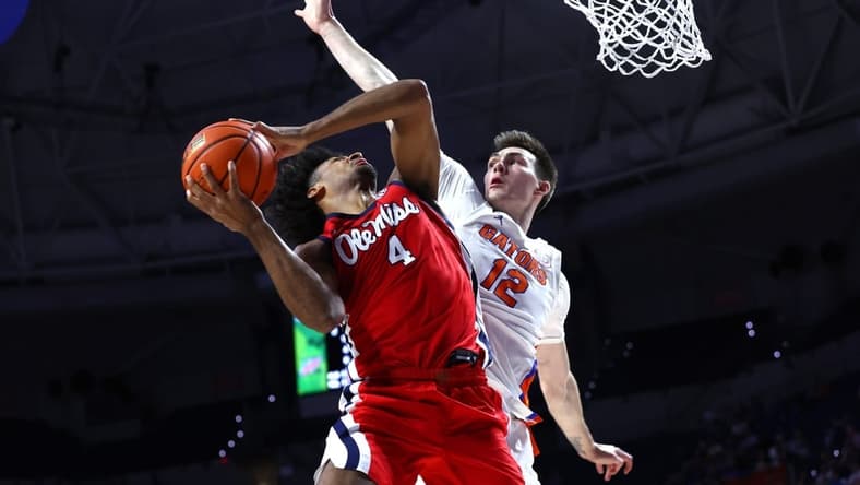 Feb 15, 2023; Gainesville, Florida, USA; Florida Gators forward Colin Castleton (12) defends Mississippi Rebels forward Jaemyn Brakefield (4) during the first half at Exactech Arena at the Stephen C. O'Connell Center. Mandatory Credit: Kim Klement-USA TODAY Sports