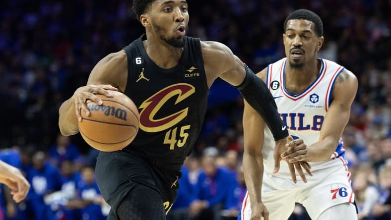 Feb 15, 2023; Philadelphia, Pennsylvania, USA; Cleveland Cavaliers guard Donovan Mitchell (45) drives past Philadelphia 76ers guard De'Anthony Melton (8) during the first quarter at Wells Fargo Center. Mandatory Credit: Bill Streicher-USA TODAY Sports