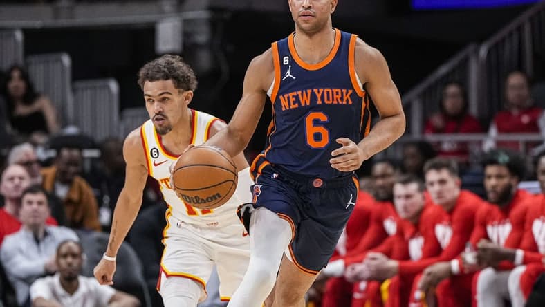 Feb 15, 2023; Atlanta, Georgia, USA; New York Knicks guard Quentin Grimes (6) dribblers past Atlanta Hawks guard Trae Young (11) during the first half at State Farm Arena. Mandatory Credit: Dale Zanine-USA TODAY Sports