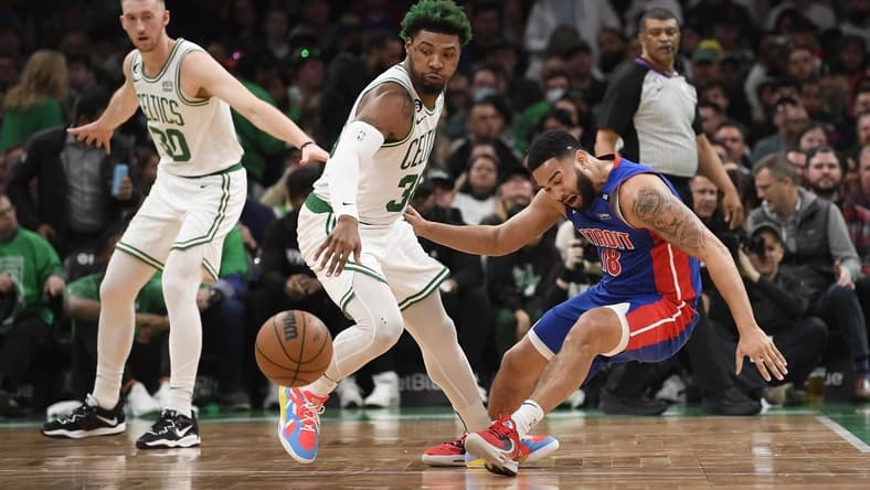 Feb 15, 2023; Boston, Massachusetts, USA; Boston Celtics guard Marcus Smart (36) steals the ball from Detroit Pistons guard Cory Joseph (18) during the first half at TD Garden. Mandatory Credit: Bob DeChiara-USA TODAY Sports
