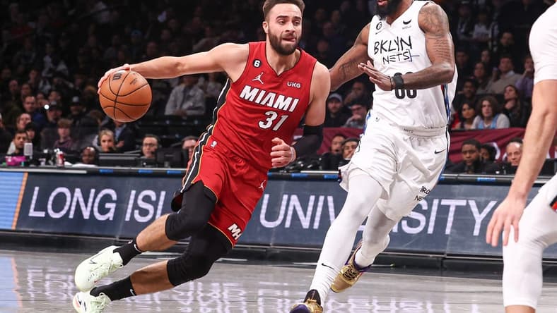 Feb 15, 2023; Brooklyn, New York, USA; Miami Heat guard Max Strus (31) shoots the ball against Brooklyn Nets forward Royce O'Neale (00) during the first half at Barclays Center. Mandatory Credit: Vincent Carchietta-USA TODAY Sports