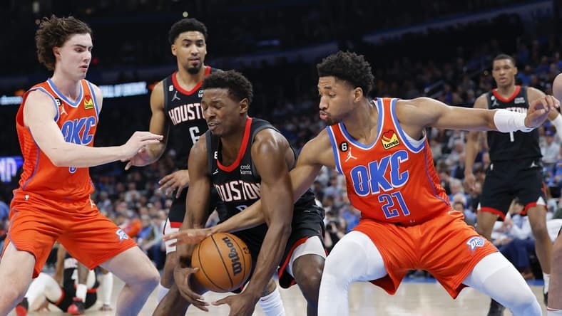 Feb 15, 2023; Oklahoma City, Oklahoma, USA; Houston Rockets forward Jae'Sean Tate (8) looses control of the ball between Oklahoma City Thunder guard Aaron Wiggins (21) and guard Josh Giddey (3) during the second quarter at Paycom Center. Mandatory Credit: Alonzo Adams-USA TODAY Sports