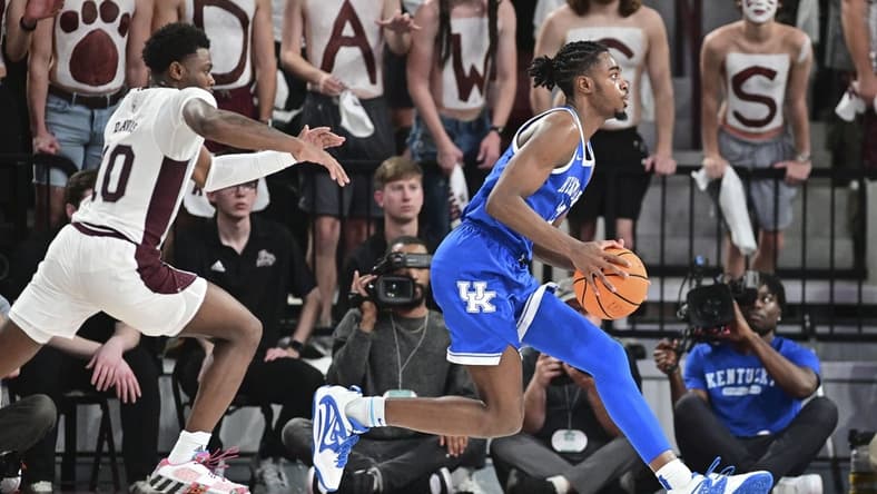Feb 15, 2023; Starkville, Mississippi, USA; Kentucky Wildcats guard Antonio Reeves (12) handles the ball while defended by Mississippi State Bulldogs guard Dashawn Davis (10) during the first half at Humphrey Coliseum. Mandatory Credit: Matt Bush-USA TODAY Sports