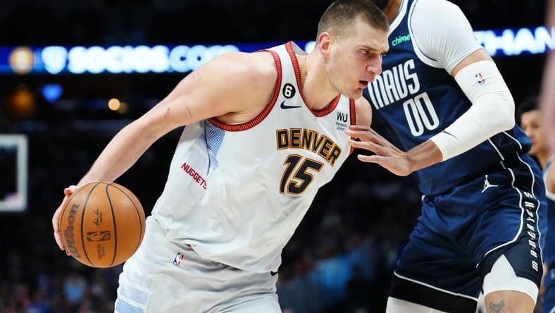 Feb 15, 2023; Denver, Colorado, USA; Dallas Mavericks center JaVale McGee (00) defends Denver Nuggets center Nikola Jokic (15) in the first quarter at Ball Arena. Mandatory Credit: Ron Chenoy-USA TODAY Sports