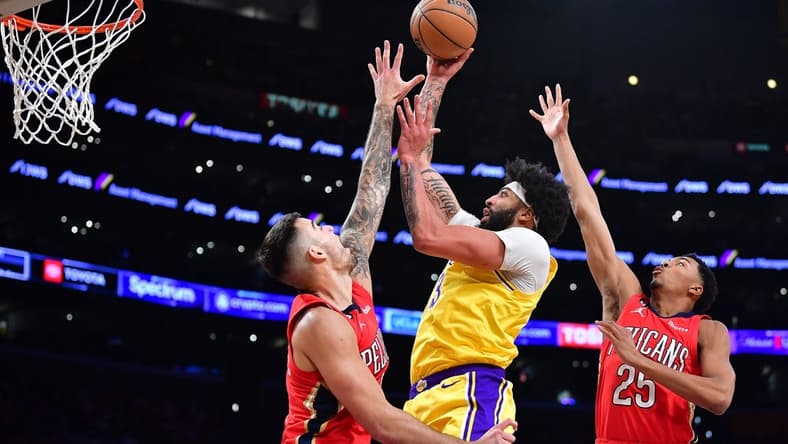 Feb 15, 2023; Los Angeles, California, USA; Los Angeles Lakers forward Anthony Davis (3) moves to the basket against New Orleans Pelicans center Willy Hernangomez (9) and guard Trey Murphy III (25) during the first half at Crypto.com Arena. Mandatory Credit: Gary A. Vasquez-USA TODAY Sports