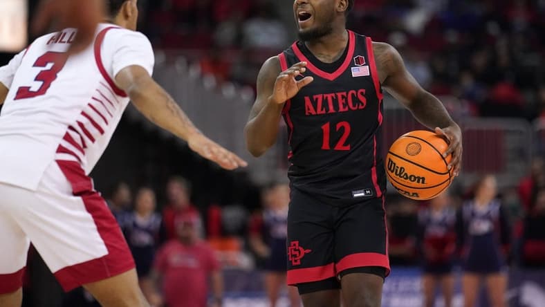 Feb 15, 2023; Fresno, California, USA; San Diego State Aztecs guard Darrion Trammell (12) dribbles the ball against the Fresno State Bulldogs in the first half at the Save Mart Center. Mandatory Credit: Cary Edmondson-USA TODAY Sports
