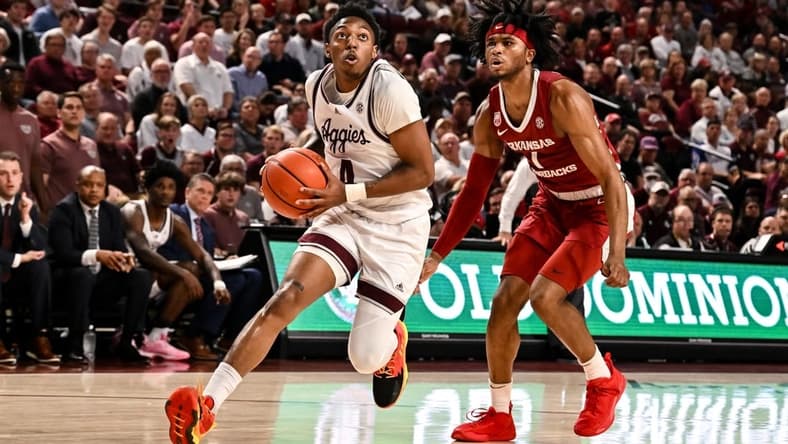 Feb 15, 2023; College Station, Texas, USA; Texas A&M Aggies guard Wade Taylor IV (4) drives through Arkansas Razorbacks guard Ricky Council IV (1) during the second half at Reed Arena. Mandatory Credit: Maria Lysaker-USA TODAY Sports