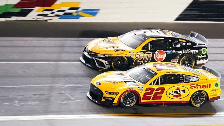 Feb 16, 2023; Daytona Beach, Florida, USA; NASCAR Cup Series driver Joey Logano (22) races to win crossing the finish line ahead of driver Christopher Bell (20) winning the Bluegreen Vacations Duel 1 at Daytona International Speedway. Mandatory Credit: John David Mercer-USA TODAY Sports