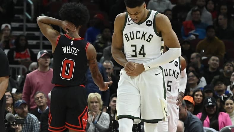 Feb 16, 2023; Chicago, Illinois, USA; Milwaukee Bucks forward Giannis Antetokounmpo (34) holds his wrist after colliding with Chicago Bulls guard Coby White (0) during the first half at the United Center. Mandatory Credit: Matt Marton-USA TODAY Sports