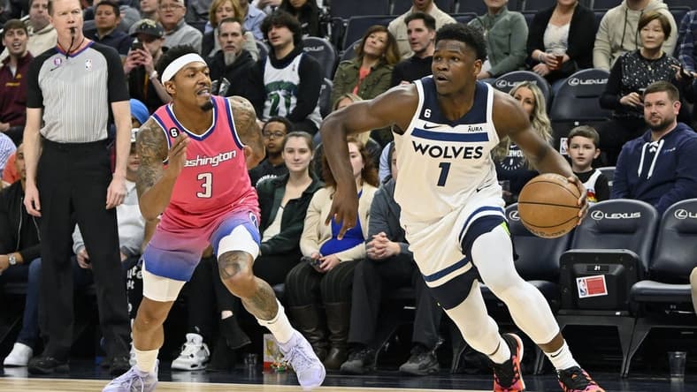 Feb 16, 2023; Minneapolis, Minnesota, USA; Minnesota Timberwolves guard Anthony Edwards (1) goes baseline as Washington Wizzards guard Bradley Beal (3) gives chase during the first quarter at Target Center. Mandatory Credit: Nick Wosika-USA TODAY Sports