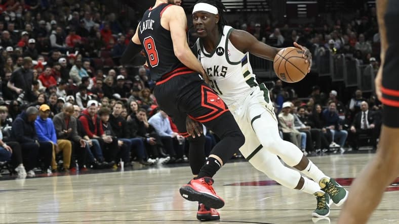 Feb 16, 2023; Chicago, Illinois, USA; Milwaukee Bucks guard Jrue Holiday (21) drives to the basket against Chicago Bulls guard Zach LaVine (8) during the first half at the United Center. Mandatory Credit: Matt Marton-USA TODAY Sports