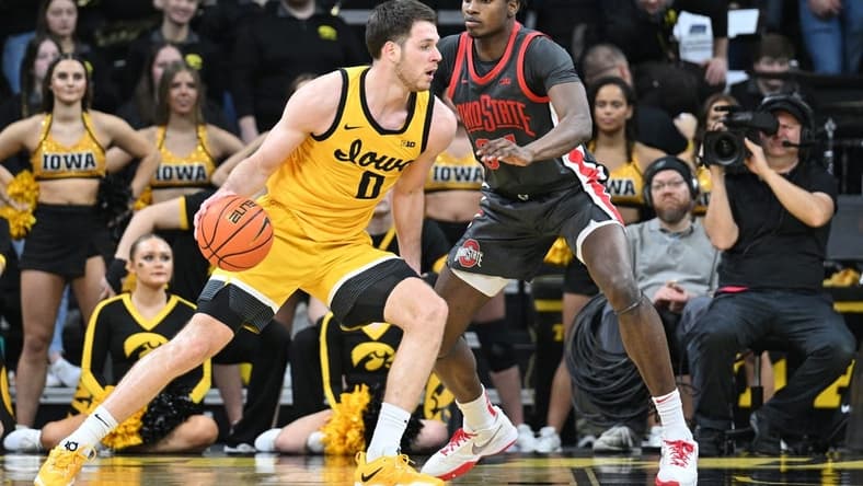 Feb 16, 2023; Iowa City, Iowa, USA; Iowa Hawkeyes forward Filip Rebraca (0) controls the ball as Ohio State Buckeyes center Felix Okpara (34) defends during the first half at Carver-Hawkeye Arena. Mandatory Credit: Jeffrey Becker-USA TODAY Sports