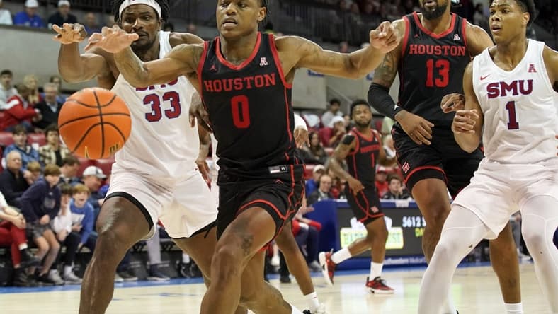 Feb 16, 2023; Dallas, Texas, USA; Houston Cougars guard Marcus Sasser (0) and Southern Methodist Mustangs forward Franklin Agunanne (33) reach for the loose ball during the second half at Moody Coliseum. Mandatory Credit: Raymond Carlin III-USA TODAY Sports