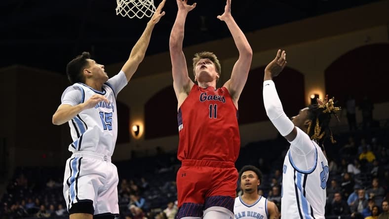 Feb 16, 2023; San Diego, California, USA; Saint Mary's Gaels center Mitchell Saxen (11) shoots the ball while defended by San Diego Toreros guard Neel Beniwal (15) during the first half at Jenny Craig Pavilion. Mandatory Credit: Orlando Ramirez-USA TODAY Sports