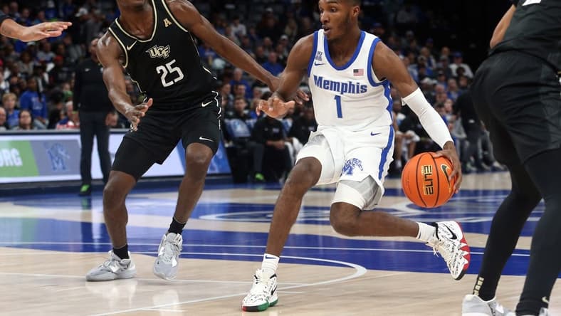 Feb 16, 2023; Memphis, Tennessee, USA; Memphis Tigers guard Keonte Kennedy (1) dribbles as UCF Knights forward Taylor Hendricks (25) defends during the first half at FedExForum. Mandatory Credit: Petre Thomas-USA TODAY Sports