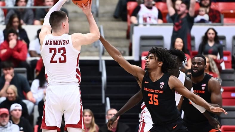 Feb 16, 2023; Pullman, Washington, USA; Washington State Cougars forward Andrej Jakimovski (23) shoots the ball against Oregon State Beavers forward Glenn Taylor Jr. (35) in the first half at Friel Court at Beasley Coliseum. Mandatory Credit: James Snook-USA TODAY Sports
