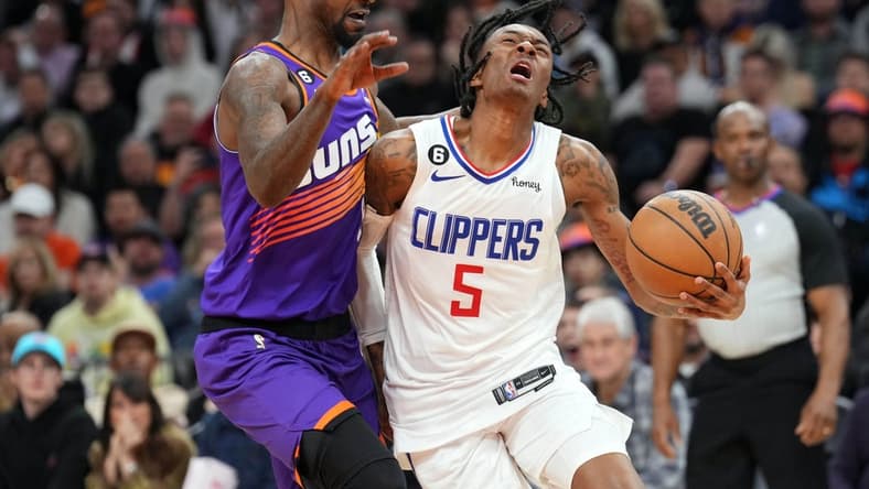 Feb 16, 2023; Phoenix, Arizona, USA; Phoenix Suns guard Terrence Ross (8) fouls LA Clippers guard Bones Hyland (5) during the second half at Footprint Center. Mandatory Credit: Joe Camporeale-USA TODAY Sports