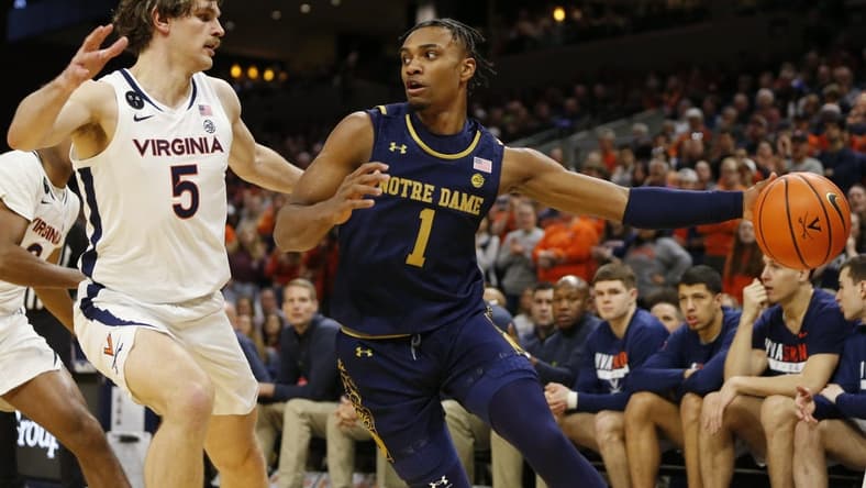 Feb 18, 2023; Charlottesville, Virginia, USA; Notre Dame Fighting Irish guard J.J. Starling (1) controls the ball as Virginia Cavaliers forward Ben Vander Plas (5) defends during the first half at John Paul Jones Arena. Mandatory Credit: Amber Searls-USA TODAY Sports