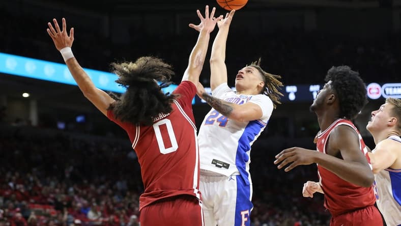 Feb 18, 2023; Fayetteville, Arkansas, USA; Florida Gators guard Riley Kugel (24) shoots over Arkansas Razorbacks guard Anthony Black (0) in the first half at Bud Walton Arena. Mandatory Credit: Nelson Chenault-USA TODAY Sports