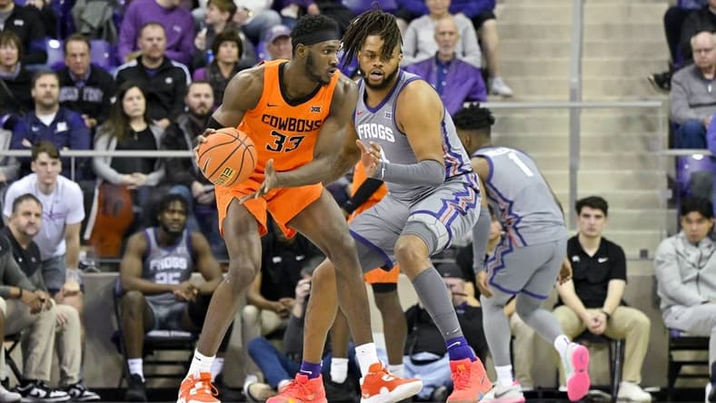 Feb 18, 2023; Fort Worth, Texas, USA; Oklahoma State Cowboys forward Moussa Cisse (33) looks to move the ball past TCU Horned Frogs center Eddie Lampkin Jr. (4) during the first half at the Ed and Rae Schollmaier Arena. Mandatory Credit: Jerome Miron-USA TODAY Sports