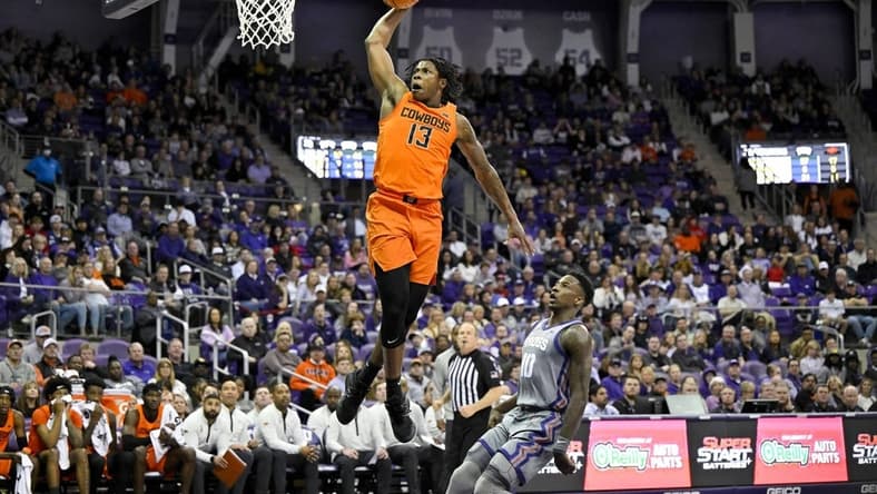 Feb 18, 2023; Fort Worth, Texas, USA; Oklahoma State Cowboys guard Quion Williams (13) dunks the ball as TCU Horned Frogs guard Damion Baugh (10) looks on during the second half at the Ed and Rae Schollmaier Arena. Mandatory Credit: Jerome Miron-USA TODAY Sports