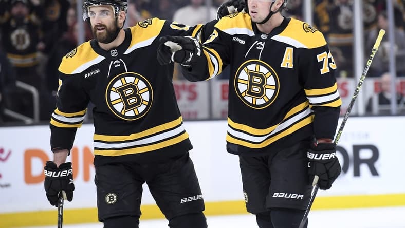 Feb 18, 2023; Boston, Massachusetts, USA; Boston Bruins defenseman Charlie McAvoy (73) reacts with left wing Nick Foligno (17) after a tip in goal by center Trent Frederic (11) (not pictured) during the first period against the New York Islanders at TD Garden. Mandatory Credit: Bob DeChiara-USA TODAY Sports