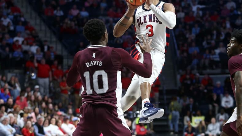 Feb 18, 2023; Oxford, Mississippi, USA; Mississippi Rebels forward Myles Burns (3) shoots as Mississippi State Bulldogs guard Dashawn Davis (10) defends during the second half at The Sandy and John Black Pavilion at Ole Miss. Mandatory Credit: Petre Thomas-USA TODAY Sports