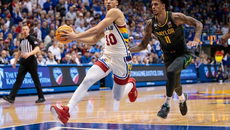 Feb 18, 2023; Lawrence, Kansas, USA; Kansas Jayhawks forward Jalen Wilson (10) drives to the basket around Baylor Bears forward Jalen Bridges (11) during the second half at Allen Fieldhouse. Mandatory Credit: William Purnell-USA TODAY Sports
