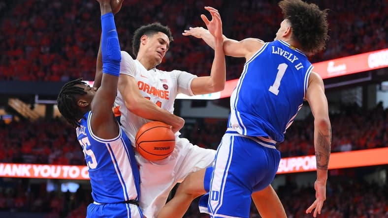 Feb 18, 2023; Syracuse, New York, USA; Syracuse Orange center Jesse Edwards (14) loses control of the ball as Duke Blue Devils forward Mark Mitchell (25) and center Dereck Lively II (1) defend during the first half at the JMA Wireless Dome. Mandatory Credit: Rich Barnes-USA TODAY Sports