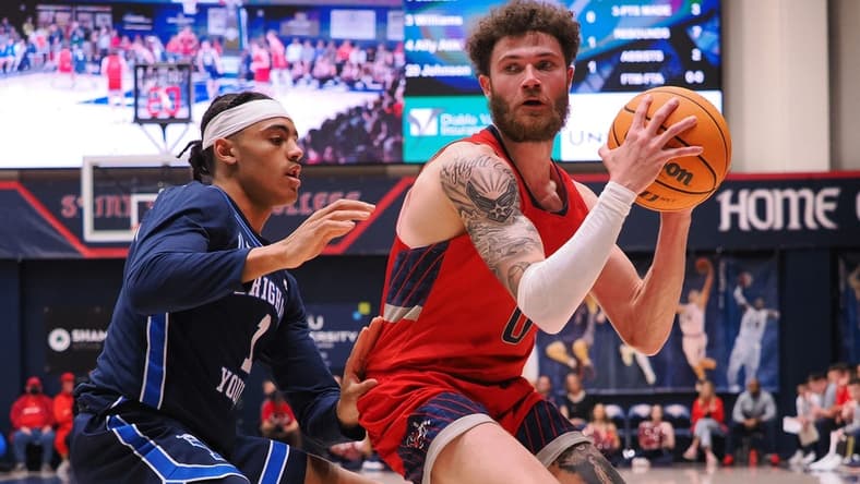 Feb 18, 2023; Moraga, California, USA; St. Mary's Gaels guard Logan Johnson (0) controls the ball against BYU Cougars guard Trey Stewart (1) during the first half at University Credit Union Pavilion. Mandatory Credit: Kelley L Cox-USA TODAY Sports