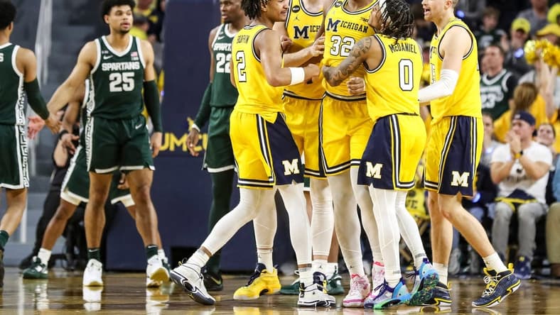 Michigan players celebrate a play against Michigan State made by forward Tarris Reed Jr. (32) during the second half at Crisler Center in Ann Arbor on Saturday, Feb. 18, 2023.