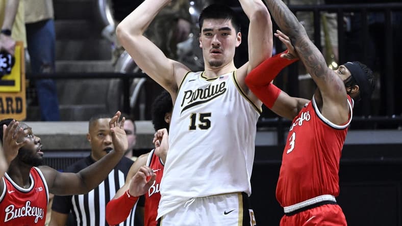 Feb 19, 2023; West Lafayette, Indiana, USA; Purdue Boilermakers center Zach Edey (15) keeps the ball away from Ohio State Buckeyes guard Eugene Brown III (3) during the first half at Mackey Arena. Mandatory Credit: Marc Lebryk-USA TODAY Sports
