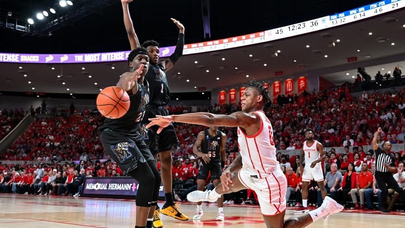 Feb 19, 2023; Houston, Texas, USA; Houston Cougars guard Marcus Sasser (0) passes the ball around Memphis Tigers forward Malcolm Dandridge (23) during the second half at Fertitta Center. Mandatory Credit: Maria Lysaker-USA TODAY Sports